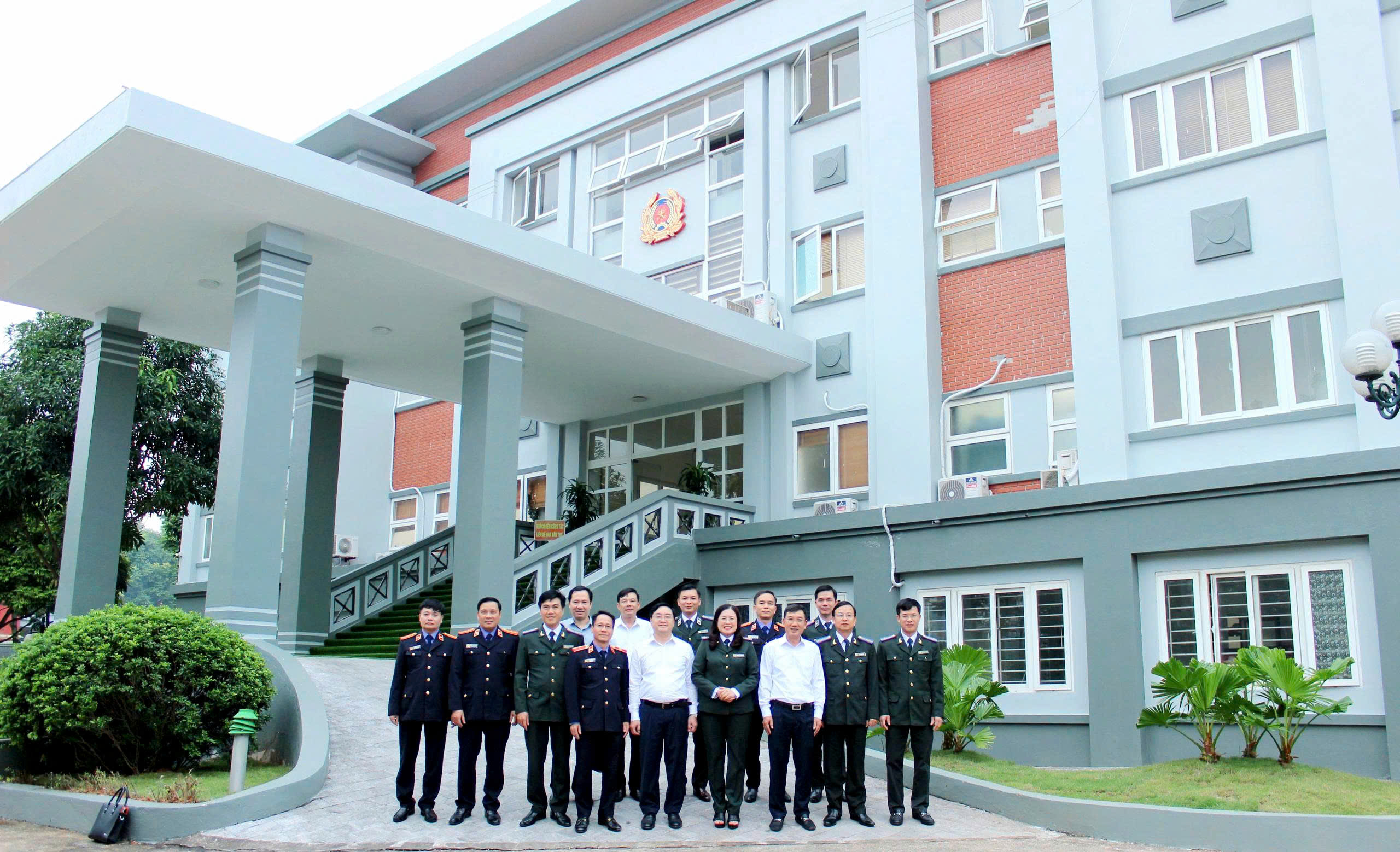 A group of people standing in front of a buildingAI-generated content may be incorrect.